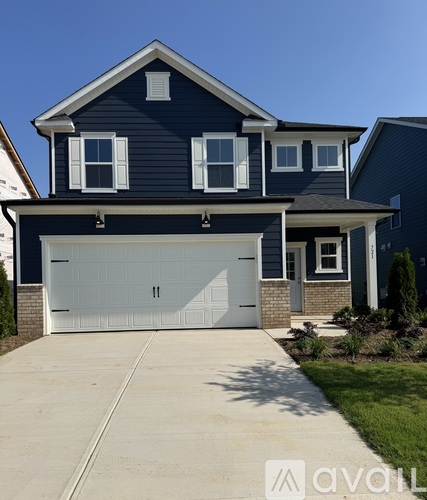 A two-story house with a garage door in the middle.
