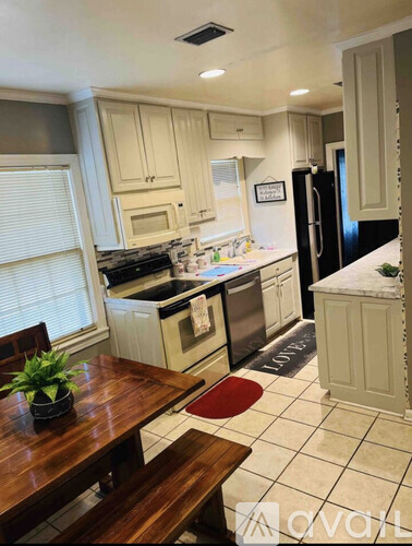 A kitchen with a wooden table and a plant on it.
