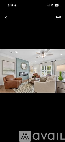 A living room with a brown leather chair and a beige armchair.