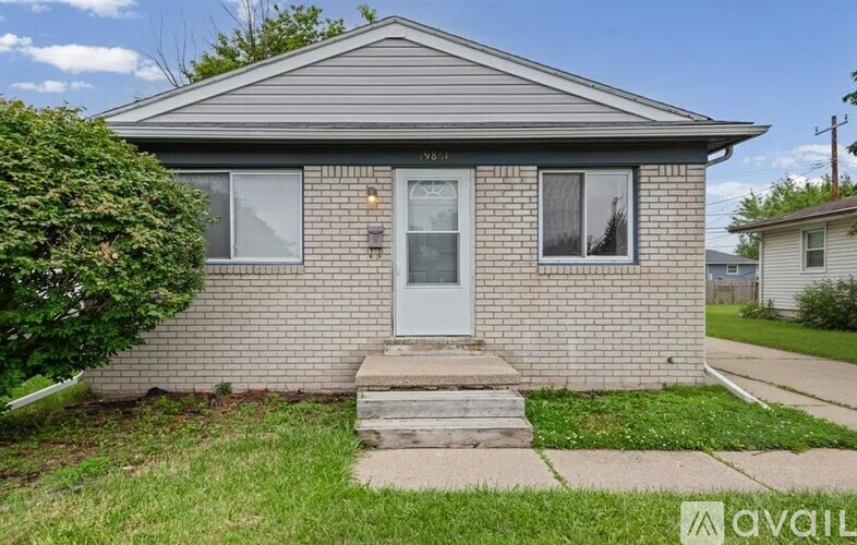 A house with a grey roof and a white door is for sale.