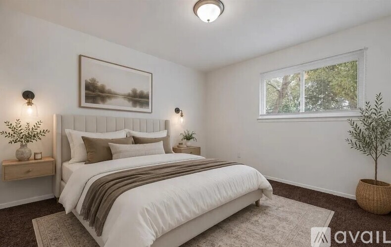 A bedroom with a large bed and a window.