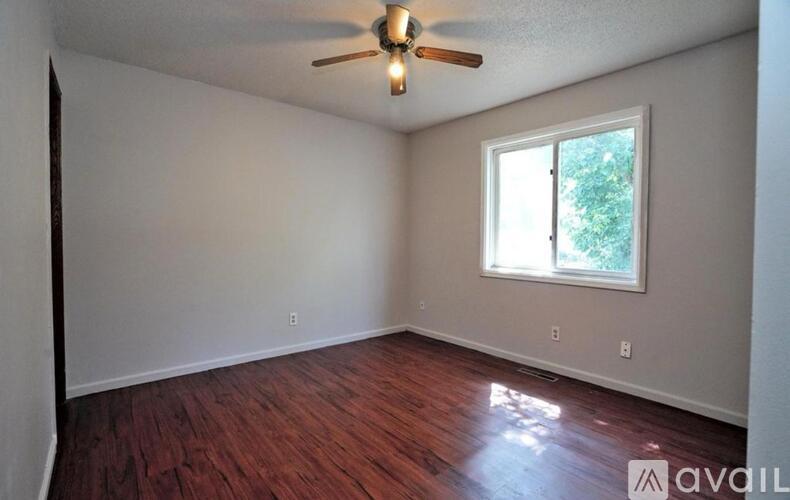 A room with a ceiling fan and a window.