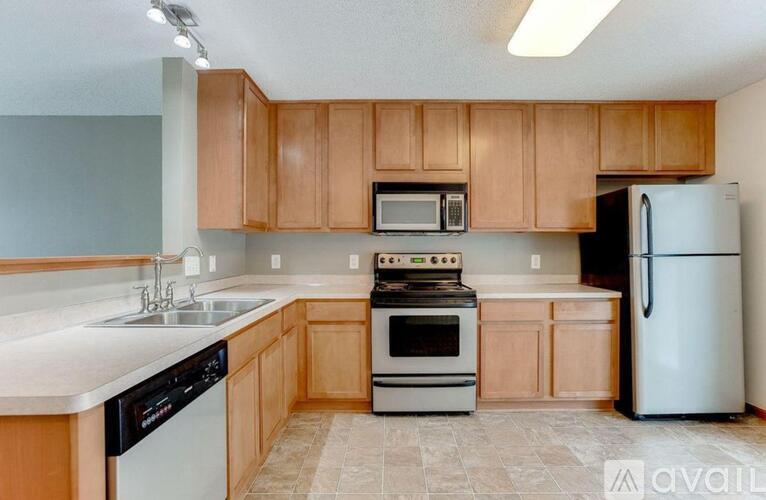 A kitchen with wooden cabinets and a white refrigerator.