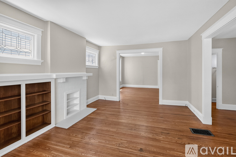 A room with a fireplace and wood flooring.