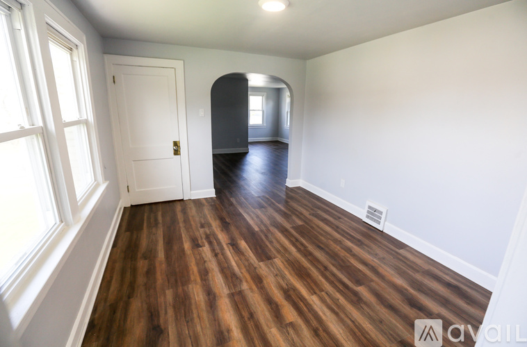 A room with wooden floors and white walls.