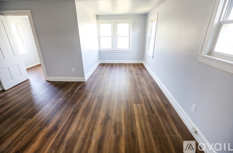 A room with wooden floors and white walls.
