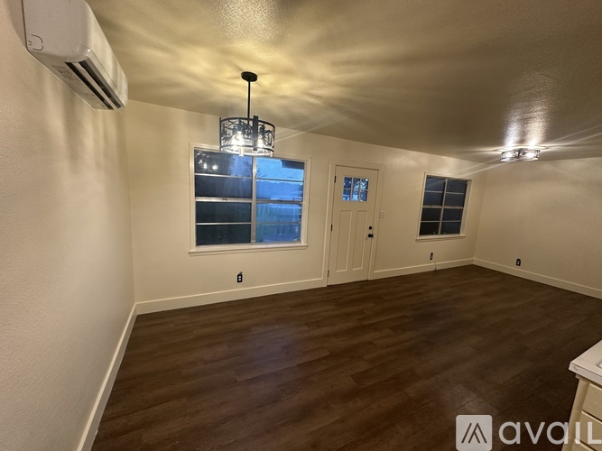 A room with wooden floors and a ceiling light.