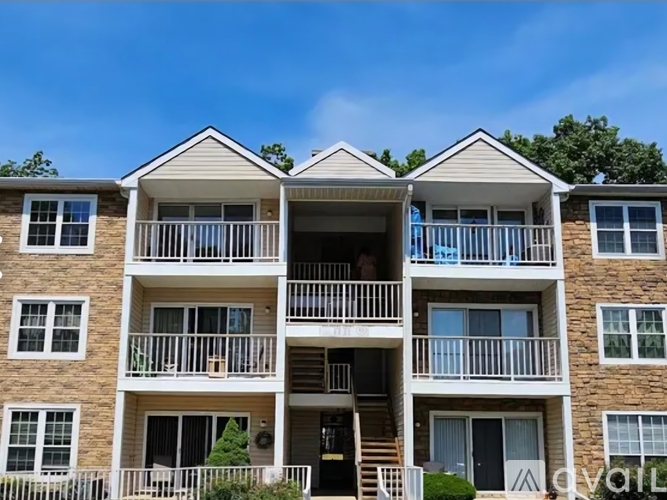 A multi-story apartment building with balconies and windows.