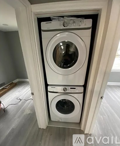 A white washing machine and dryer in a small laundry room.