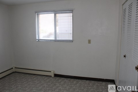 A room with a window and a door.