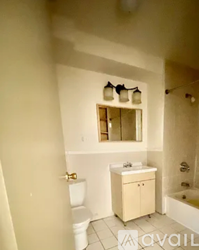 A bathroom with a toilet, sink, and tub.