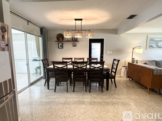 A dining room with a table set for six.