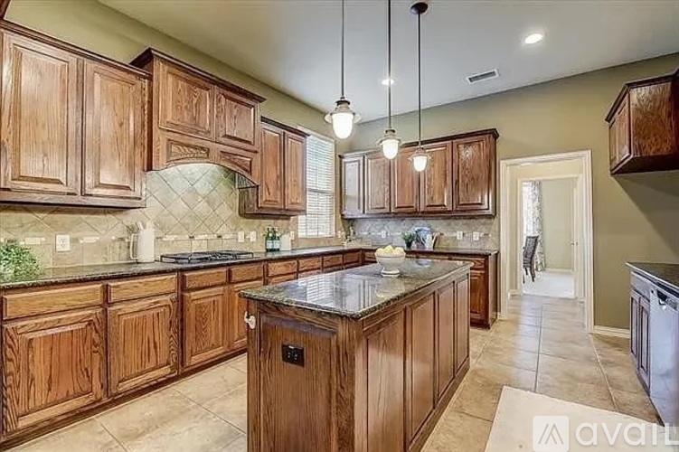 A kitchen with wooden cabinets and a granite countertop.