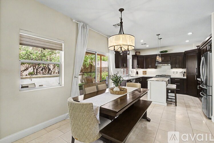 A modern kitchen with a dining table and chairs.