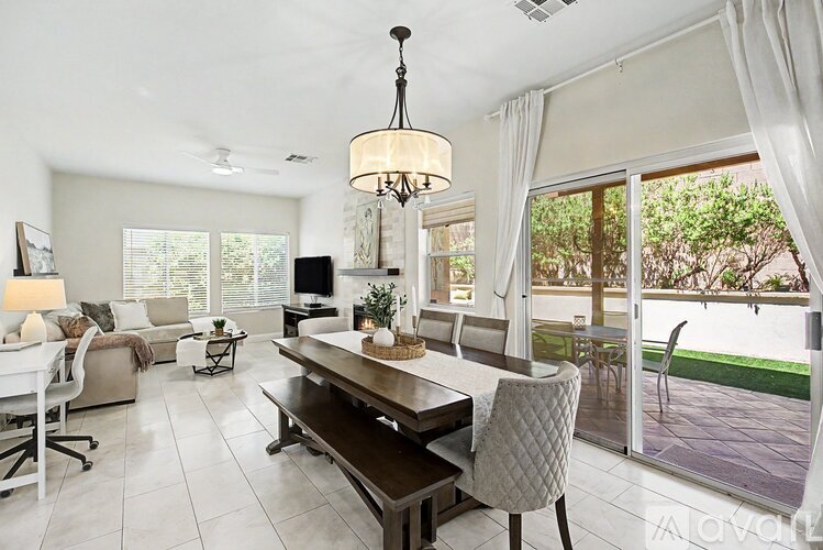 A well-lit, modern dining room with a table set for four.