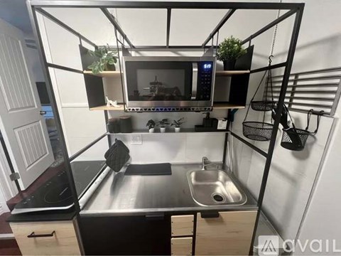 A small kitchen with a sink and a microwave.