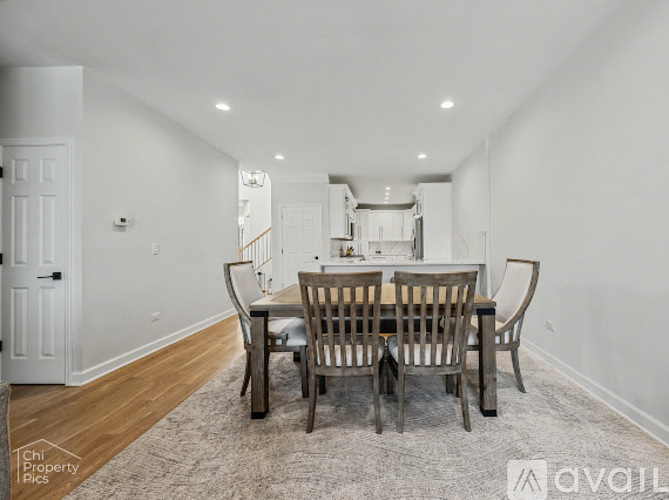 A dining room with a table set for six.