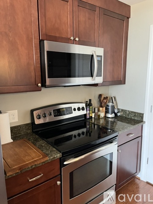 A kitchen with a stove top oven and microwave above it.