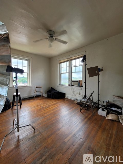 A room with wooden floors and a ceiling fan.
