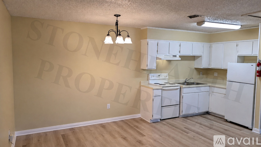 A kitchen area with a wall that says Stone Property.