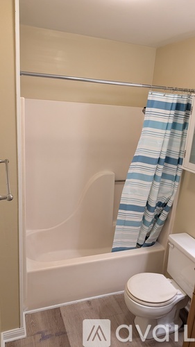 A small bathroom with a toilet and a shower.