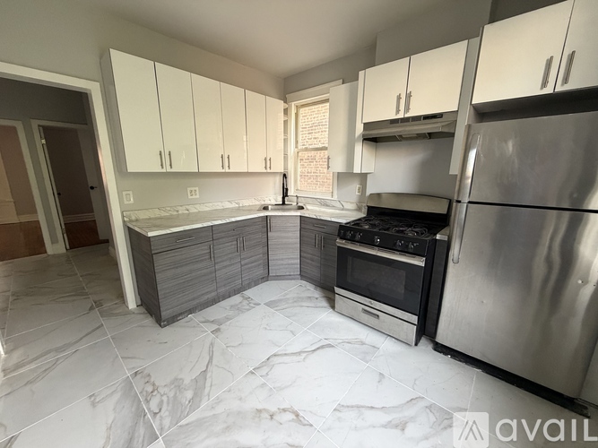 A kitchen with stainless steel appliances and marble countertops.