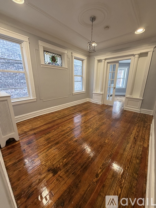 A room with wooden floors and white walls.