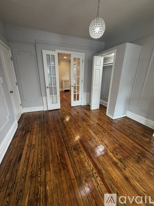 A room with wooden floors and white walls.