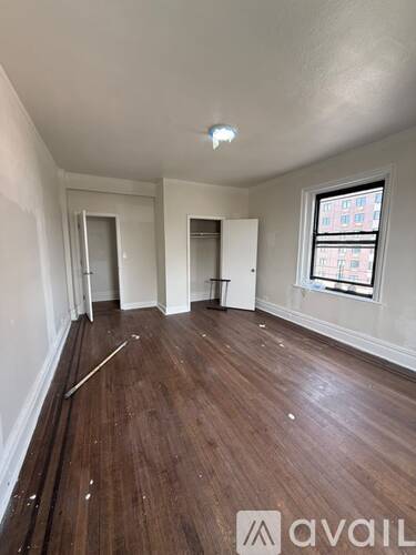 Empty room with wooden floors and white walls.