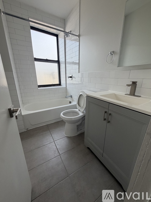 A bathroom with a toilet, sink, and bathtub.