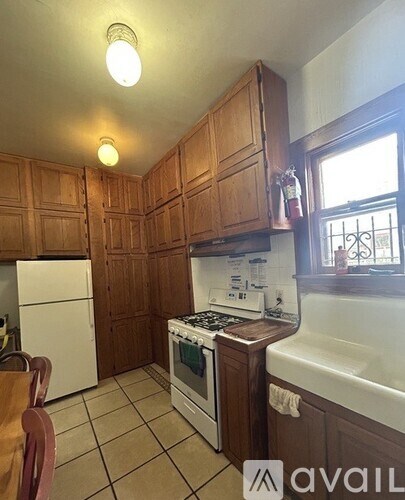 A kitchen with wooden cabinets and a white refrigerator.