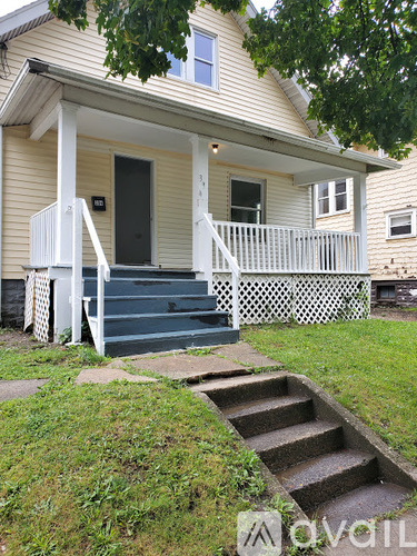 A house with a front porch and stairs leading up to it.