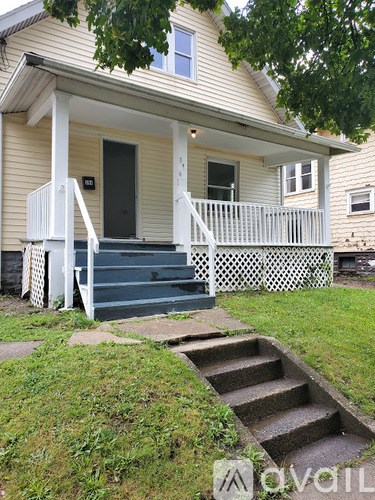 A house with a front porch and stairs leading up to it.