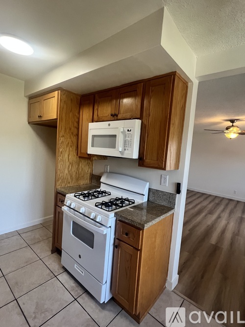 A kitchen with a stove, oven, and microwave.