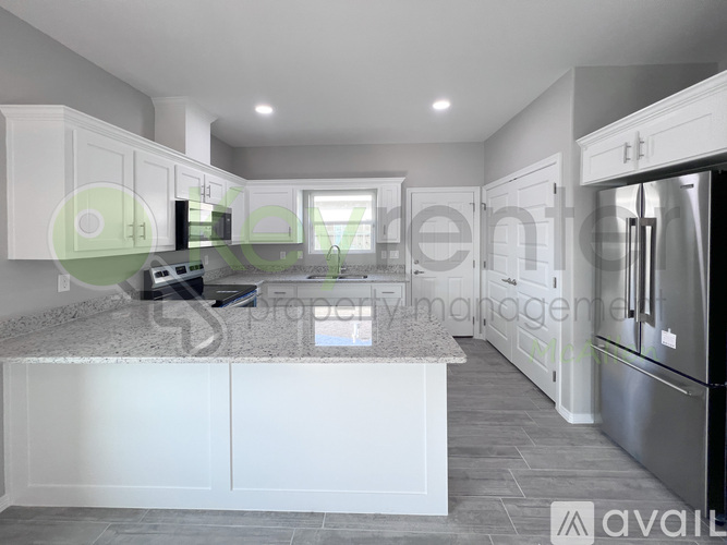 A modern kitchen with white cabinets and a central island.