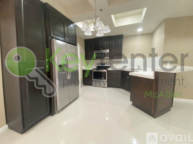 A modern kitchen with a refrigerator and a stove top oven.