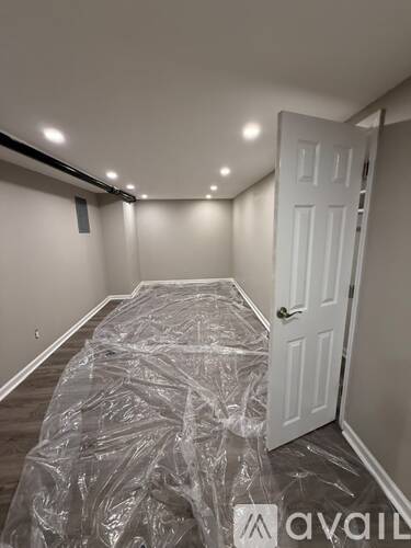 A room with a door covered in plastic.