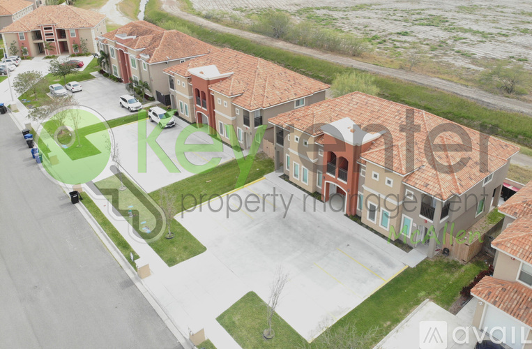A row of houses with a green logo in the foreground.