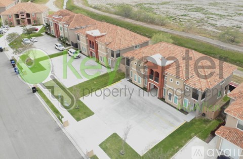 A row of houses with a green logo in the foreground.
