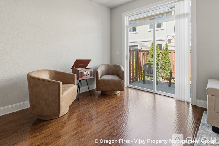 A living room with two chairs and a table.