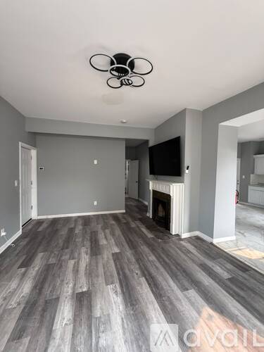A living room with a fireplace and a television.