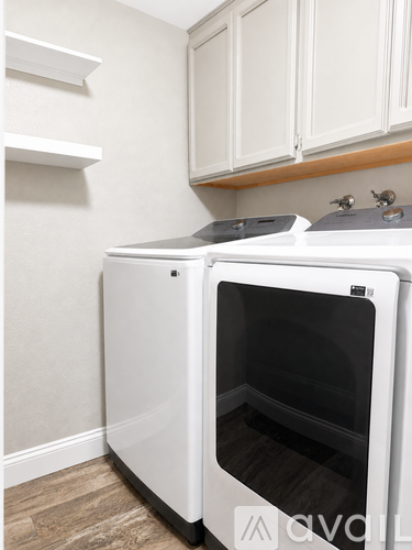 A white dishwasher and oven in a kitchen.