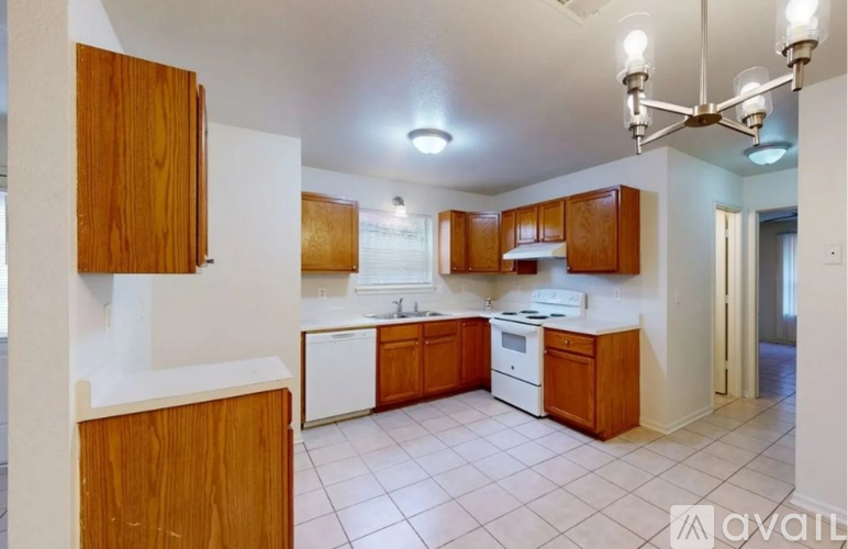 A kitchen with wooden cabinets and white appliances.