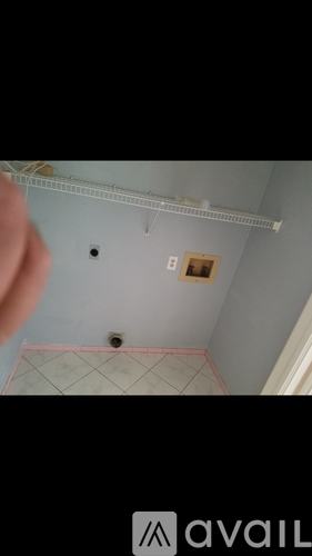 A ceiling with a light fixture and a picture frame.