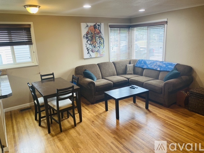 A living room with a couch, chairs, and a coffee table.