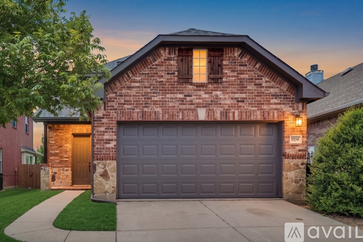 A house with a brick facade and a large garage door.