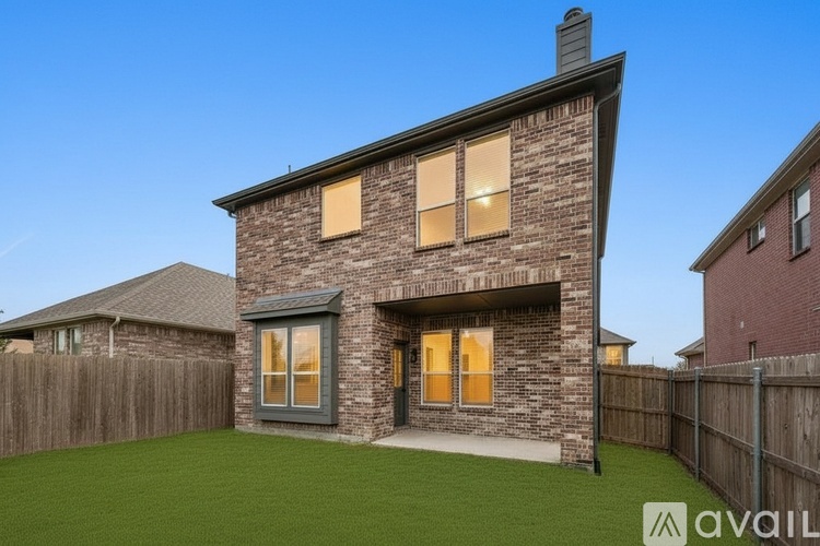 A house with a grey roof and a brown brick exterior is available for rent.