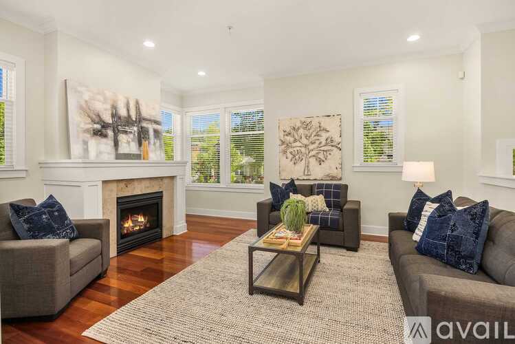 A living room with a fireplace and two couches.