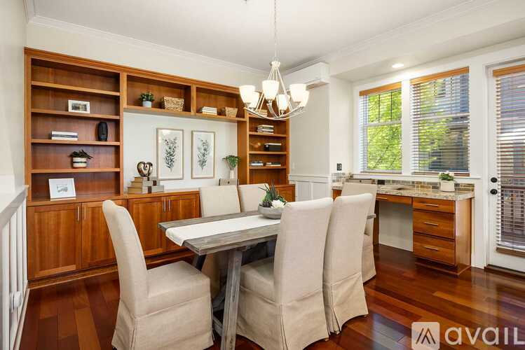 A dining room with a table and chairs.