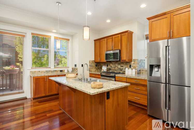 A kitchen with wooden cabinets and a granite countertop.